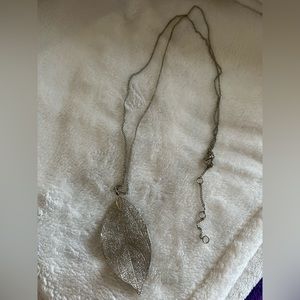 Silver tone 30” plus 3” adjustable for longer with a silver tone 3” leaf